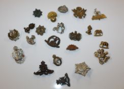 A box of military hat badges, various regiments