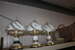 Three table lamps with glass shades together with one other table lamp and shade