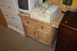A stripped pine cupboard fitted two drawers