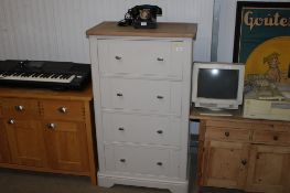 A modern pine topped chest fitted four drawers