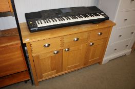A modern oak sideboard fitted three drawers