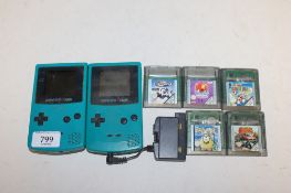 Two Nintendo Game Boy Colours and a collection of various games to include Super Mario Bros., Toki
