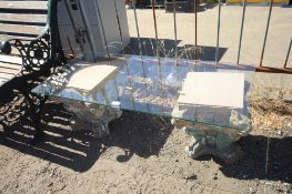 A glass topped table comprising two late 19th / early 20th Century terracotta plinths with lion mask