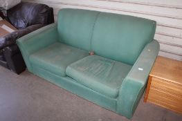 A green upholstered sofa bed