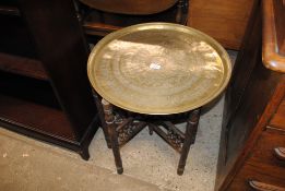 An Eastern brass tray top table