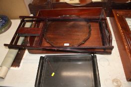 A mahogany Butlers tray; a pie crust bordered tray and a lacquered tray on folding stand