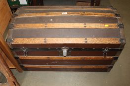 A vintage wooden bound dome topped trunk fitted interior tray