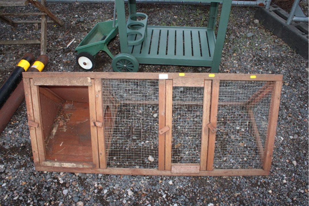 A wooden guinea pig hutch and run
