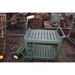 A lawn seed spreader and a garden drinks trolley