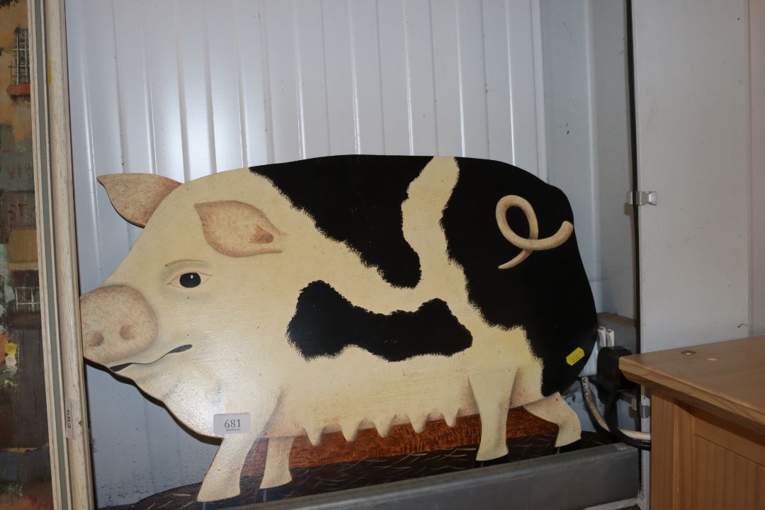 A wooden painted wall plaque of a pig