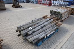Various round and square fence posts of varying lengths.