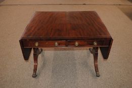 A Regency mahogany and brass strung sofa table fitted opposing drawers and dummy drawers