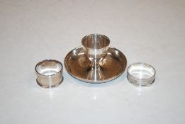 A silver egg cup with integral base, Birmingham 1972 and two silver napkin rings 107gms total