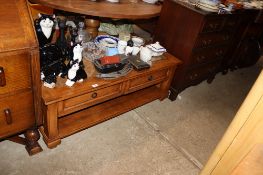 A large coffee table fitted two drawers inset with glass top