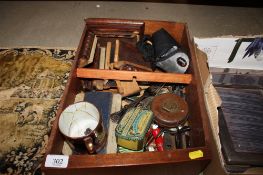 A box containing various silver plated cutlery; a leather cased tape measure; a clock case AF etc.
