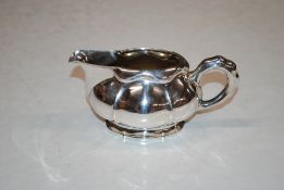 A Continental white metal compressed oval shaped cream jug, stamped 830, 151gms