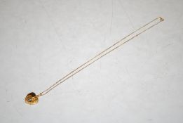 A 9ct gold heart shaped locket with silver detail, hung to 9ct gold chain, 3.8gms total weight