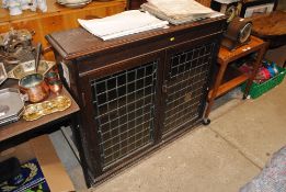 An oak and leaded glazed cabinet, the interior fitted with shelves AF