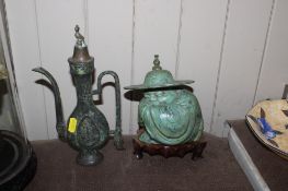 A cast metal figure and a bronze miniature ewer
