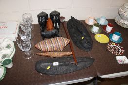 A quantity of various woodenware to include wooden club, African style face masks, a pair of