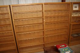 A large open fronted bookcase in two sections, each section fitted six adjustable shelves, approx.