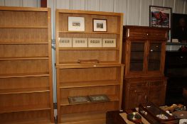 A light oak open fronted bookcase in two sections, the upper section fitted two adjustable