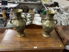 A pair of brass twin handled vases with character marks to base