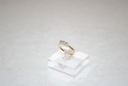 An 18ct gold and diamond three stone ring, ring size O/P, 2.6gms total weight