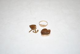 A 9ct gold ring, ring size K; a 9ct gold heart shaped locket and three 9ct gold charms, 4gms total