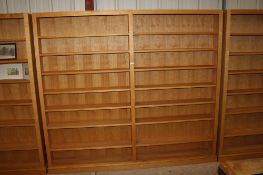 A large open fronted bookcase in two sections, each section fitted seven adjustable shelves, approx.
