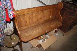 A pine pew, approx. 127cm wide x 97cm high