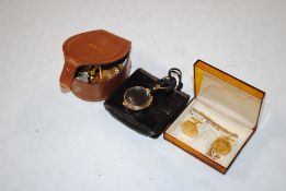 A box containing a pair of yellow metal lorgnettes engraved Dolland of London, a collection of