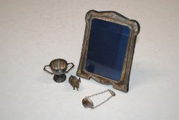 A small silver trophy cup and a Sterling silver bracelet, 43gms; a silver mounted photo frame and an