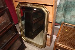 A octagonal bevel edged wall mirror contained in gilt frame