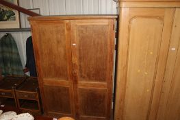 An oak two door cupboard, the interior fitted five shelves