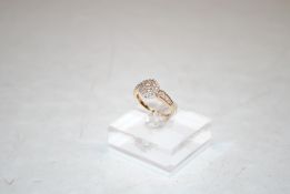 A yellow metal and diamond set cluster ring having diamond set shoulders, ring size O, 3.2gms