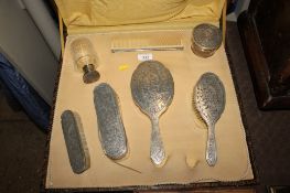 A Continental white metal marked 800 dressing table set, comprising of three brushes, hand mirror,