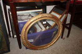 A box containing various pictures, prints and frames