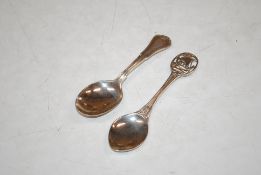 A silver caddy spoon with pierced ship motif handle, maker A.H.D & S. Birmingham 1921 and another