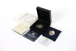A 2018 silver proof 50pence piece; a 1997 silver proof £1 coin and a Celebrating Beatrix Potter