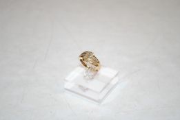 A yellow metal ring, marked 14K set with four channels of baguette cut diamonds, ring size O, 3.2gms