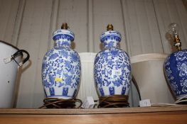 A pair of Oriental decorated blue and white baluster table lamps and shades