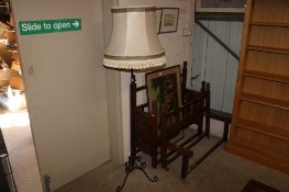 A wrought iron standard lamp and shade