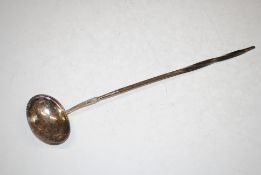 A white metal Toddy ladle