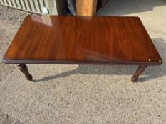 A reproduction Victorian style mahogany extending dining table fitted with centre leaf and raised on