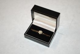 An Edwardian style 9ct gold bar brooch set with seven pearls, 3.7gms total weight