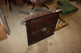 An oak hanging corner cabinet of small proportions, the interior fitted three shelves