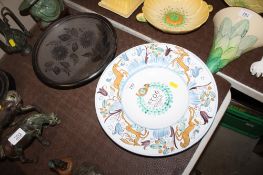 A reproduction of an 18th Century Haban Faience dish 1709; and a floral decorated pottery dish