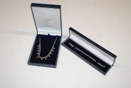 A 925 silver necklace set with white stones and a similar 925 silver bracelet, 32gms total weight