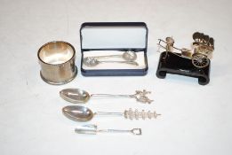 A white metal napkin ring, marked silver; three 925 Sterling silver spoons; a pair of white metal